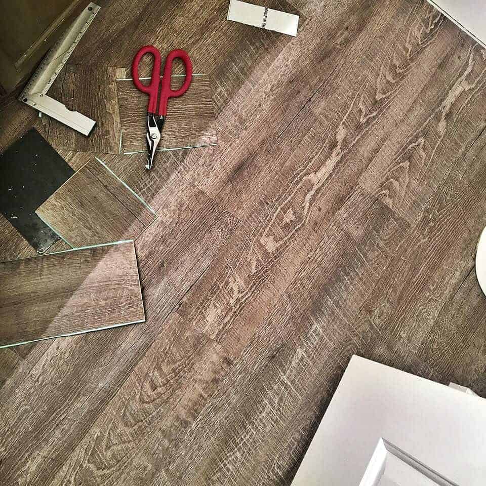 Wood Look Vinyl Plank Flooring cut with scissors